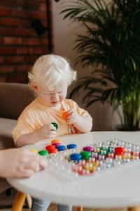 Child attending Occupational Therapy participating in client-led, play-based learning utilising a puzzle to improve problem solving skills.