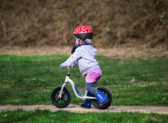 Child riding a balance bike in Body Rockers gross motor program