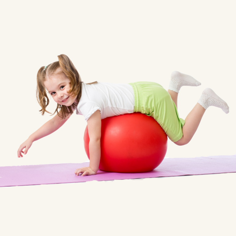 Child lying prone on a red therapy ball during paediatric exercise physiology in Kiama Downs, building balance, strength and core stability.