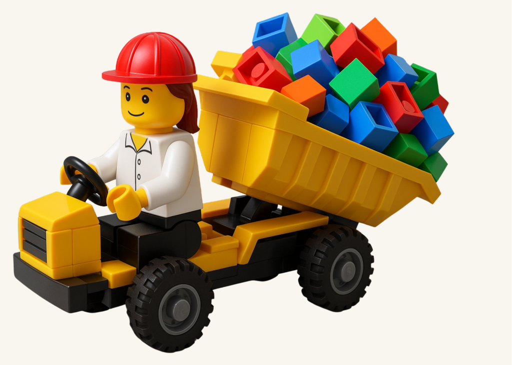 LEGO® figure driving a dump truck filled with colourful bricks, representing the Supplier role in LEGO® Based Play Therapy.