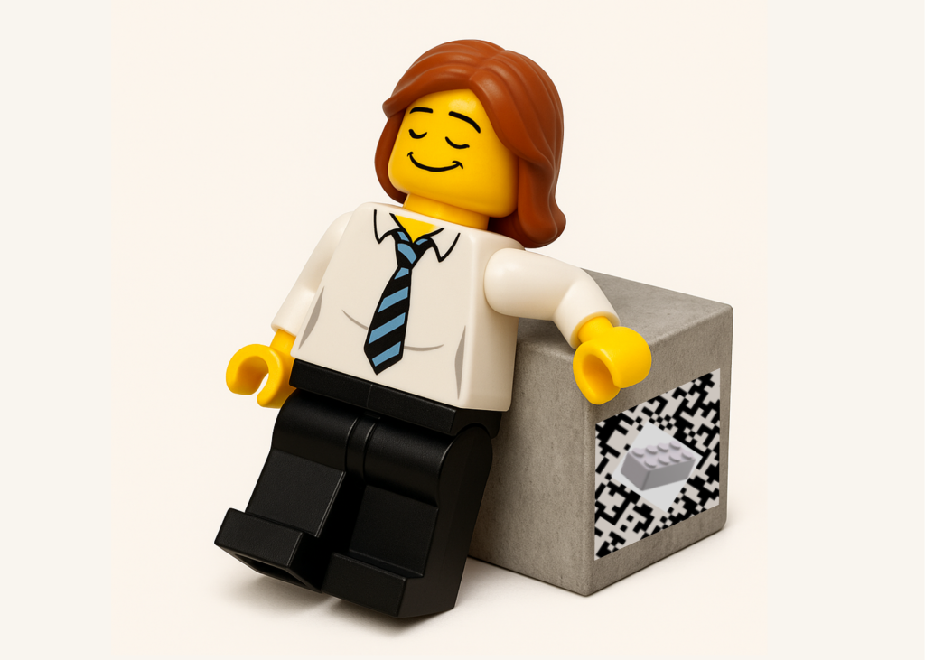 LEGO® minifigure woman leaning back against a concrete cube with a relaxed, relieved expression after putting the heavy block down.